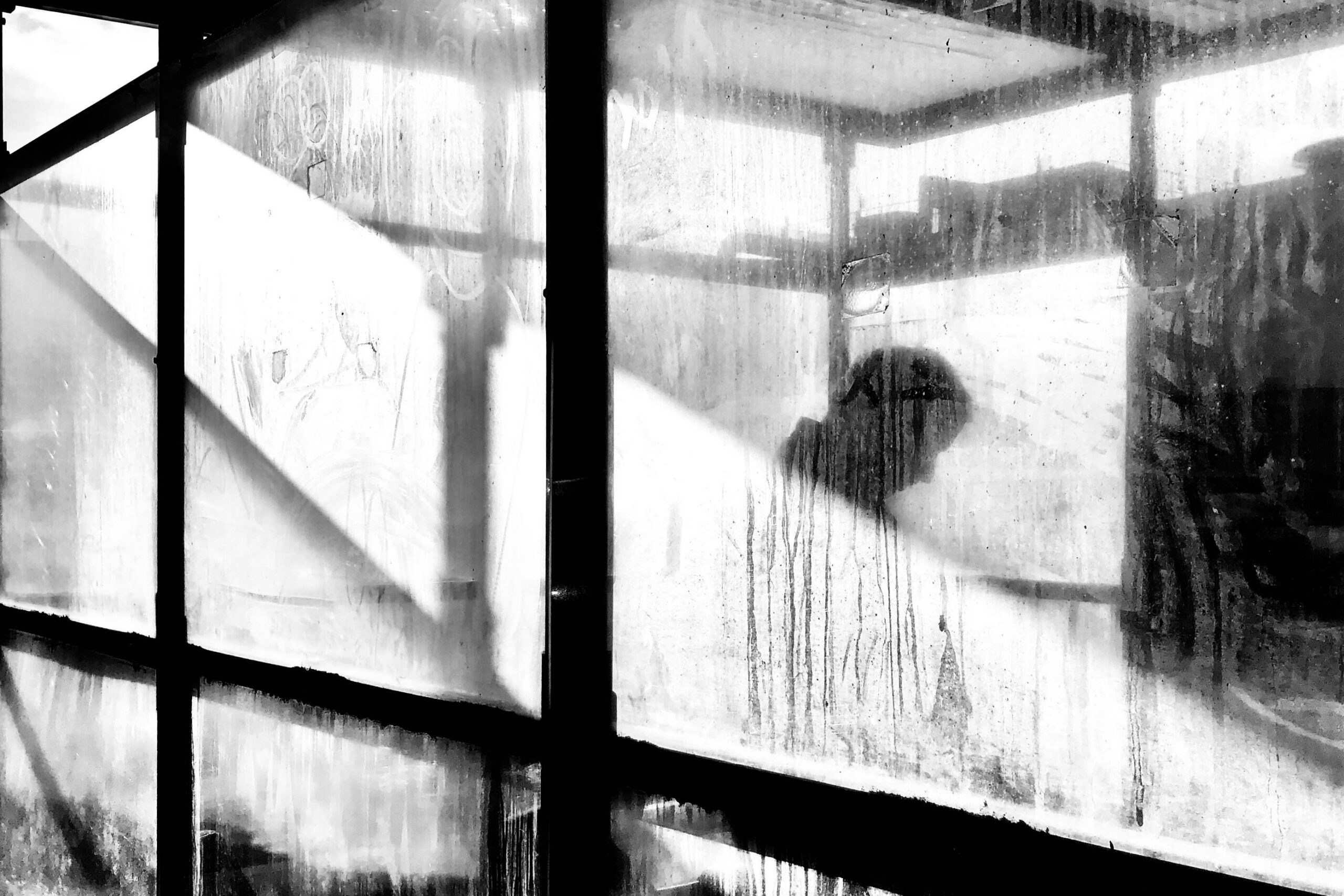 Person behind obscured window, representing support for anxiety through counselling in Darwin.