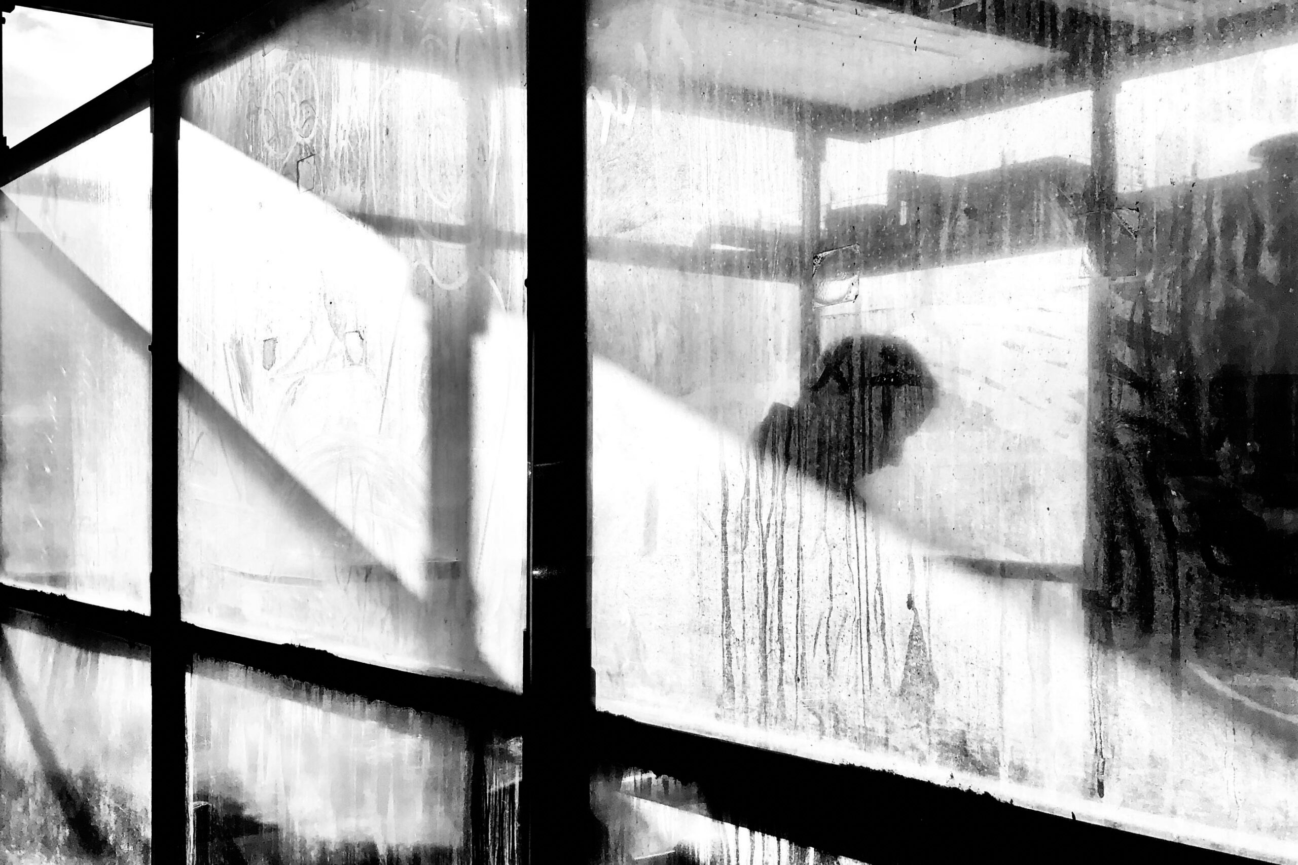 Person behind obscured window, representing support for anxiety through counselling in Darwin.