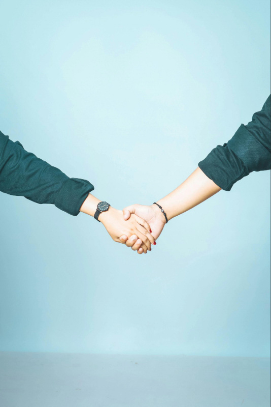 Two people holding hands, representing connection and support through relationship counselling in Darwin.