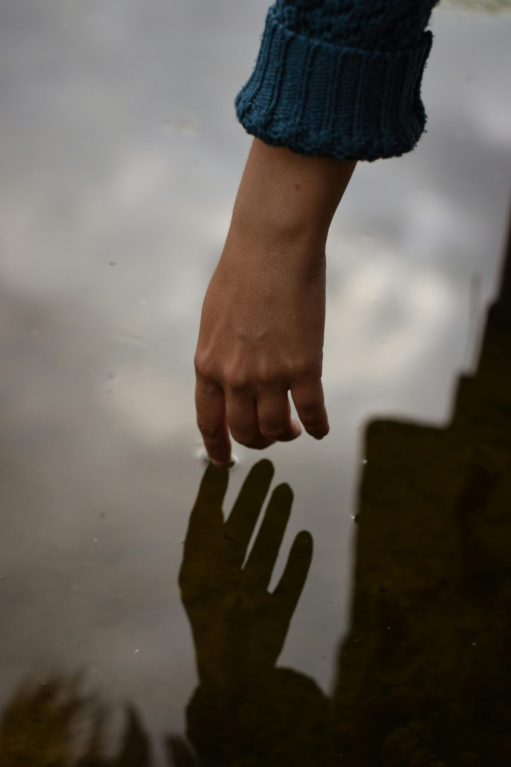 Understanding anxiety symptoms A hand reaching toward a shadow, representing the experience of anxiety symptoms and the need for support.